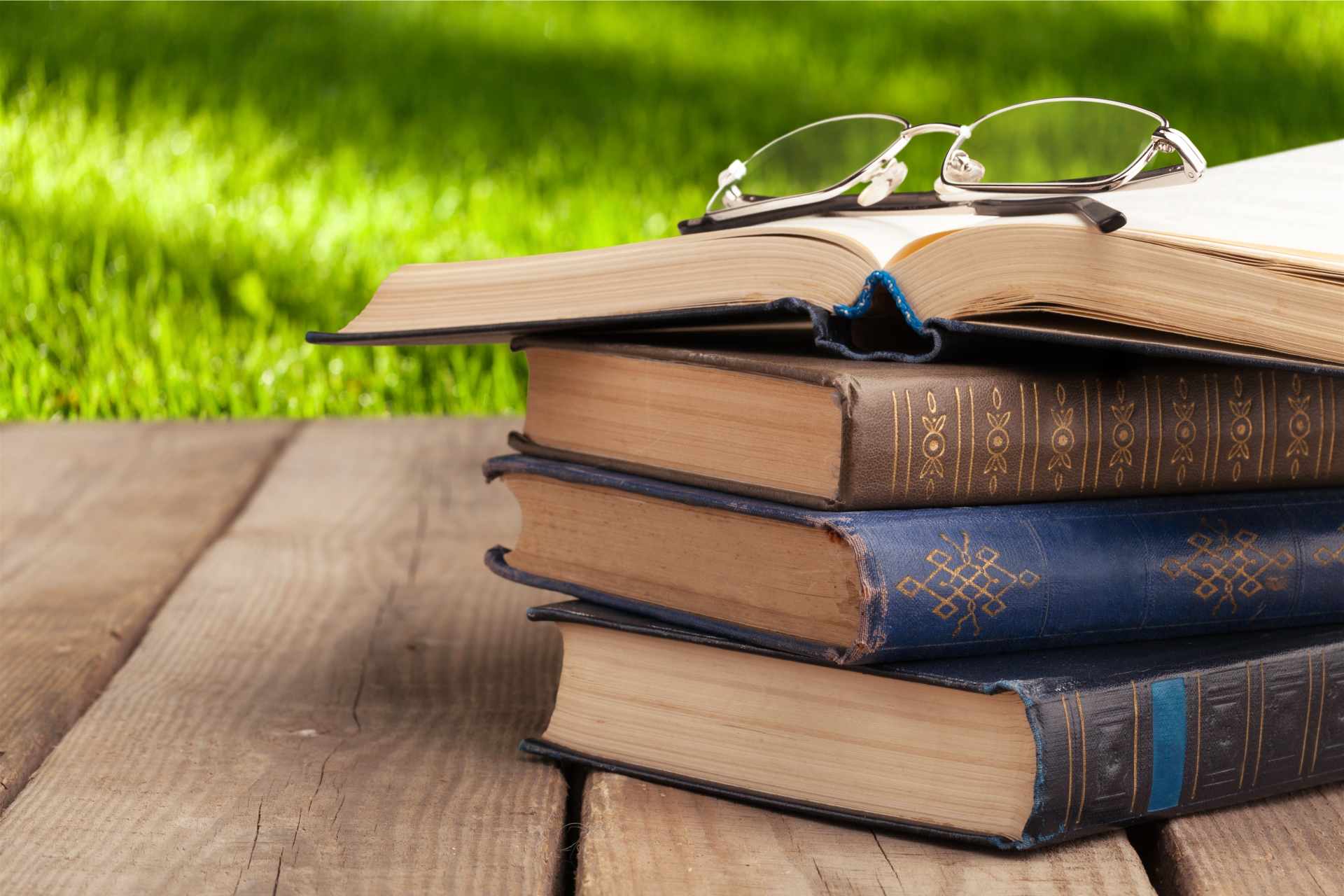 Open book on a stack outdoors, symbolizing the value of reading.