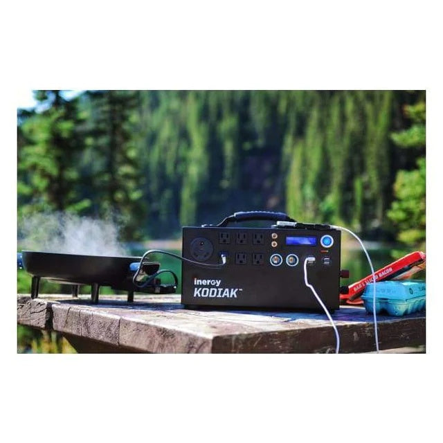 Kodiak Solar Generator powering a cooking appliance outdoors, set in a forest.