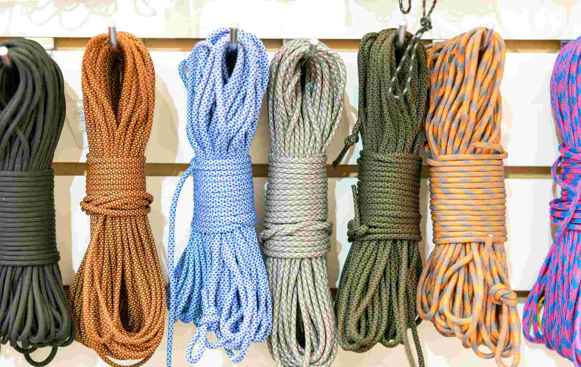 A display of ropes in various colors and patterns, demonstrating the wide range of paracords available for survival, crafting, or decorative uses.